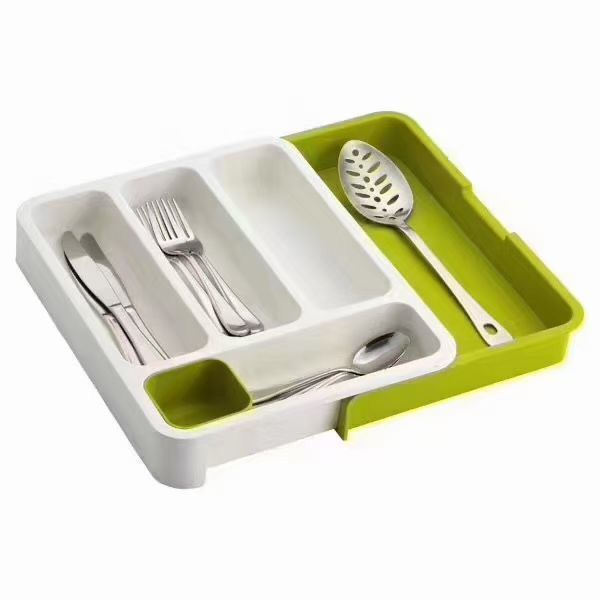 Organisateur de tiroir blanc et vert avec couverts et spatule